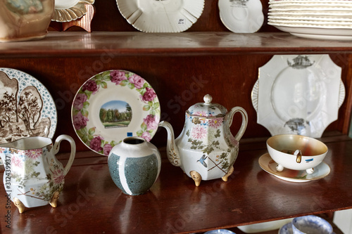 Canvas Print Vintage cabinet with decorative porcelain dishes for sale at an antique store