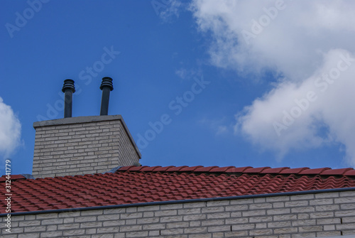 red roof and chimney against a blue sky background