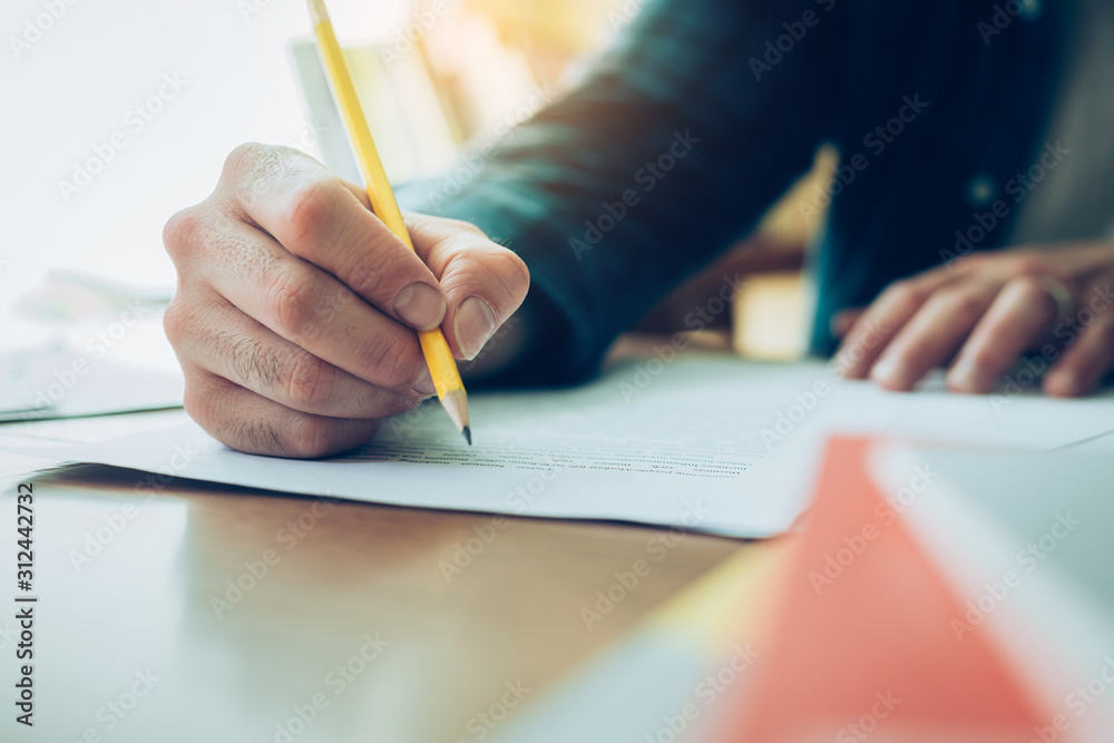 contact Asian businessman professional people thinking while working writing information documents in home offices at desk with computer,laptop,cell phone,business report chart contact Asian businessman professional people thinking while working writing information documents in home offices at desk with computer,laptop,cell phone,business report chart