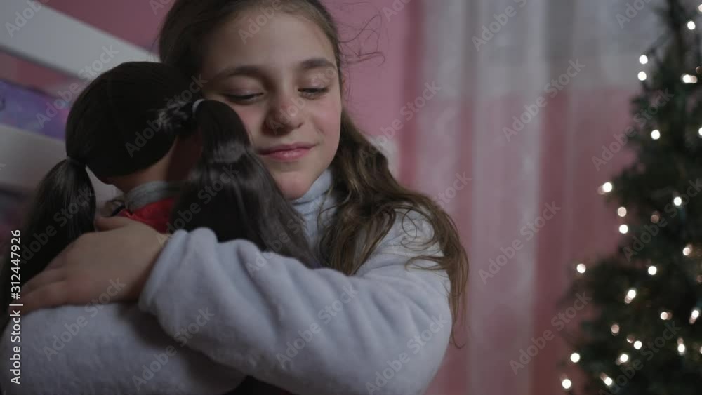 Beautiful Happy 8 Years Old Girl unwrap Christmas present box. Female child open Xmas gift near decorated fir tree. Winter holidays concept Beautiful Happy 8 Years Old Girl unwrap Christmas present box. Female child open Xmas gift near decorated fir tree. Winter holidays concept