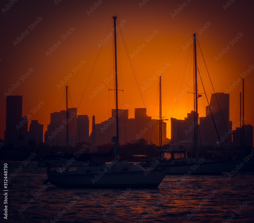 sunset harbor water sea sky orange dusk sun city buildings cloud ocean boat