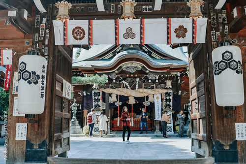 Photos Girl in red suit in front of Kushida Shrine is a Shinto shrine located in Hakata-ku, Fukuoka, Japan