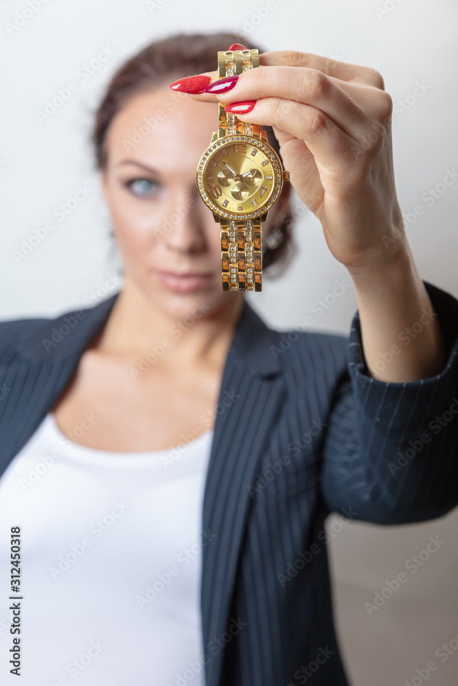Business woman with a clock in her hands