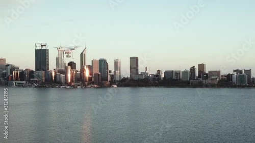 Wallpaper Mural Aerial tracking another drone flying sideways with water and cityscape in background Torontodigital.ca