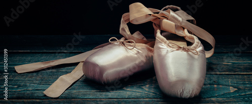 Pointes ballet shoes. Against a dark background.