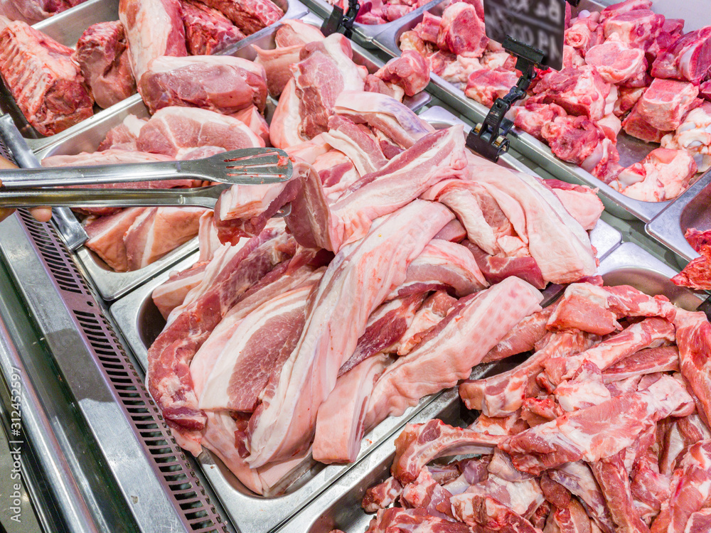 Assortment of pork meat in showcase at supermarket