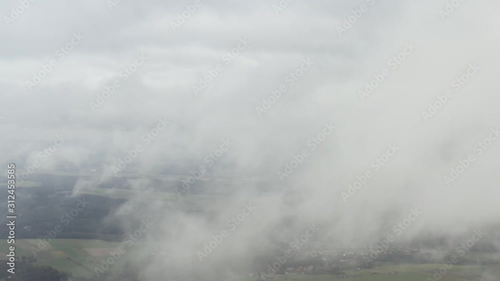 Drone flying above the clouds, beautiful aerial views of Göttingen in lower Saxony through the clouds, Germany