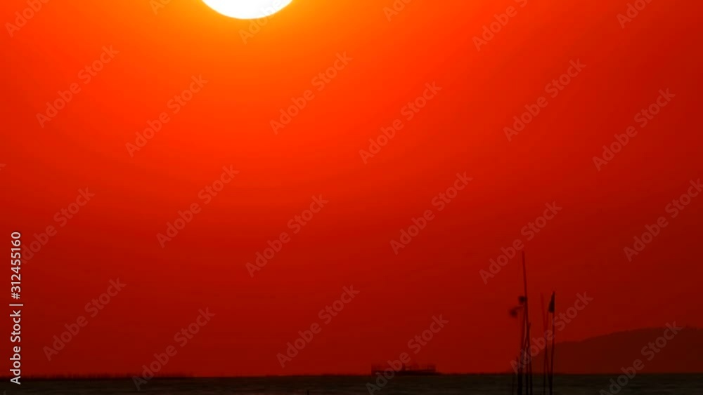 sunset red sky down back on cloud on the sea and fishing boat passing time lapse