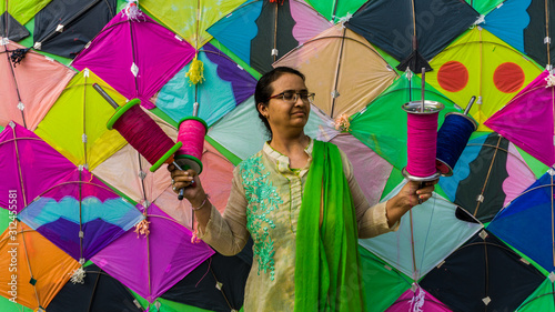 woman with Patang(kite) and firki and pipuda toy for Makar Sankranti festival of India. Makar Sankranti is kite festival of India. It is also known as uttarayan photo