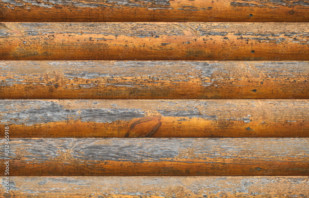 Wooden wall made of painted logs. Natural background texture Wooden wall made of painted logs. Natural background texture