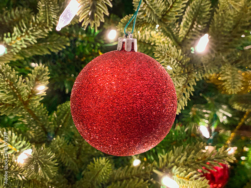 Red and gold decoration on the Christmas tree. Christmass balls on tree twig. Christmas background
