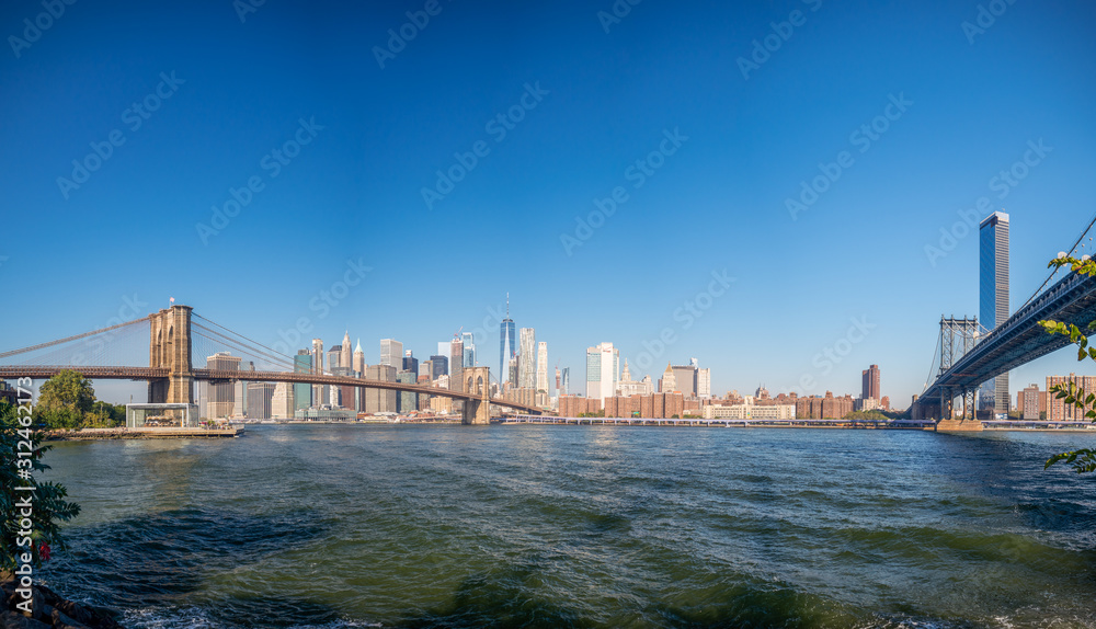 Naklejka premium Brooklyn bridge, New York, USA - September 2019: [ Brooklyn bridge architecture with panoramic view of New York City and lower Manhattan, One World Trade Center, Dumbo ]