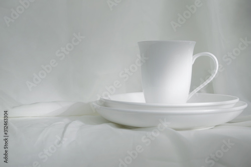 Wallpaper Mural white ceramic cup and plate on white fabric classic vintage still life background Torontodigital.ca