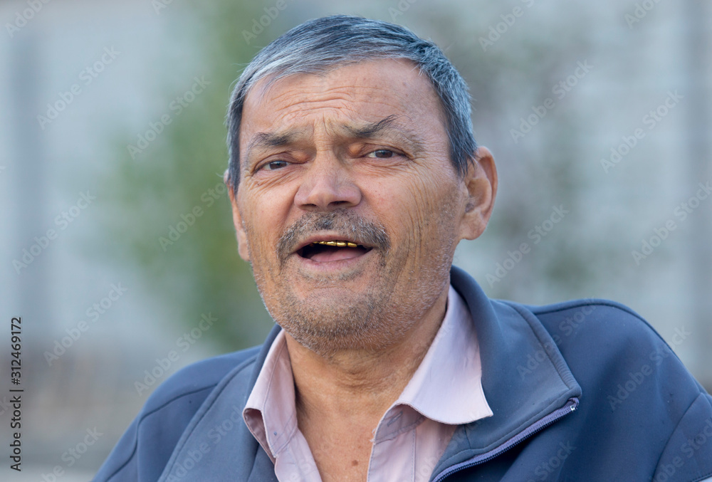 Portrait of a smiling old man outdoors