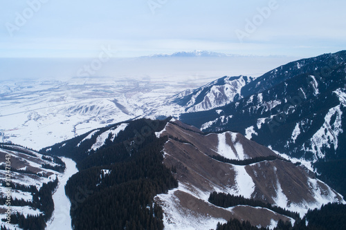 Aerial view of the Alpine skiing and snowboarding piste in mountains © lzf