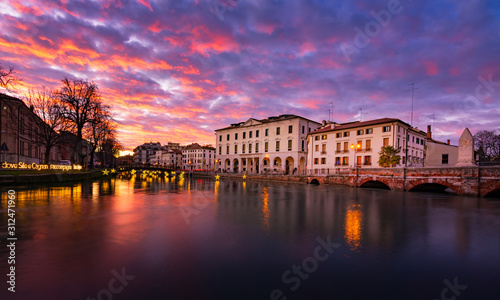 27 december 2019 (Treviso, Italy): Landscape of the University building in Treviso and the river Sile at sunset on Christmas time photo