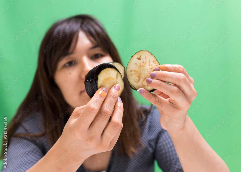 Girl preparing food on a table from eggplant