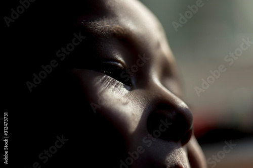 Soft light from the sun, falls on the child's face