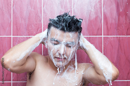 Asian handsome young man bathing in bathroom