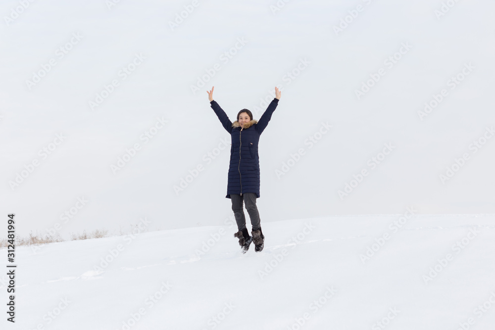 Portrait of a beautiful girl in blue jackets on the background of snow. Outdoor winter portrait Portrait of a beautiful girl in blue jackets on the background of snow. Outdoor winter portrait