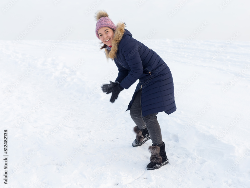 Portrait of a beautiful girl in blue jackets on the background of snow. Outdoor winter portrait Portrait of a beautiful girl in blue jackets on the background of snow. Outdoor winter portrait