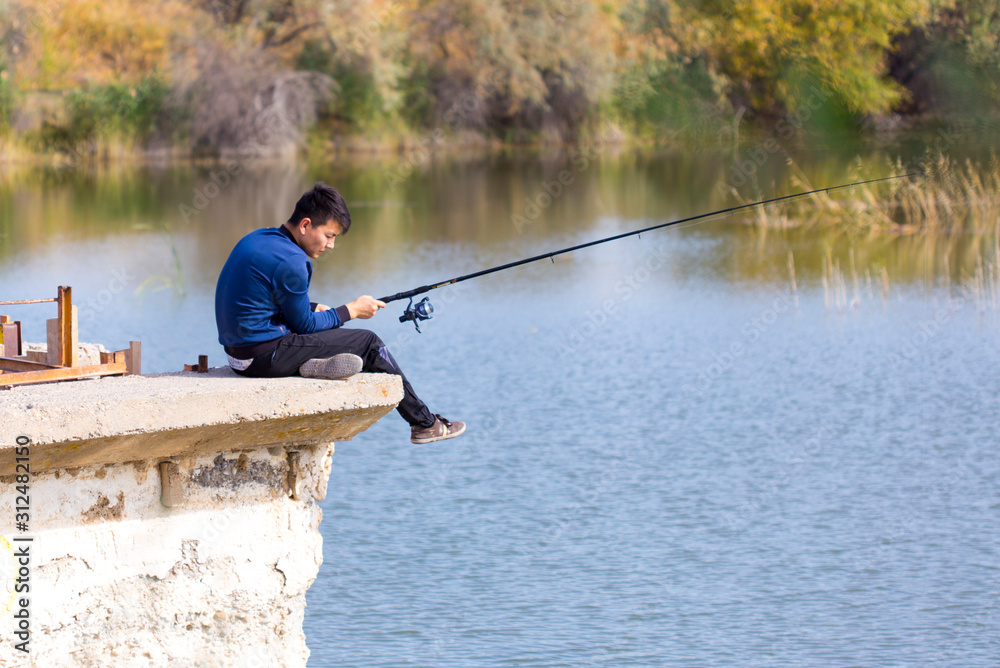 a man is fishing near a river a man is fishing near a river