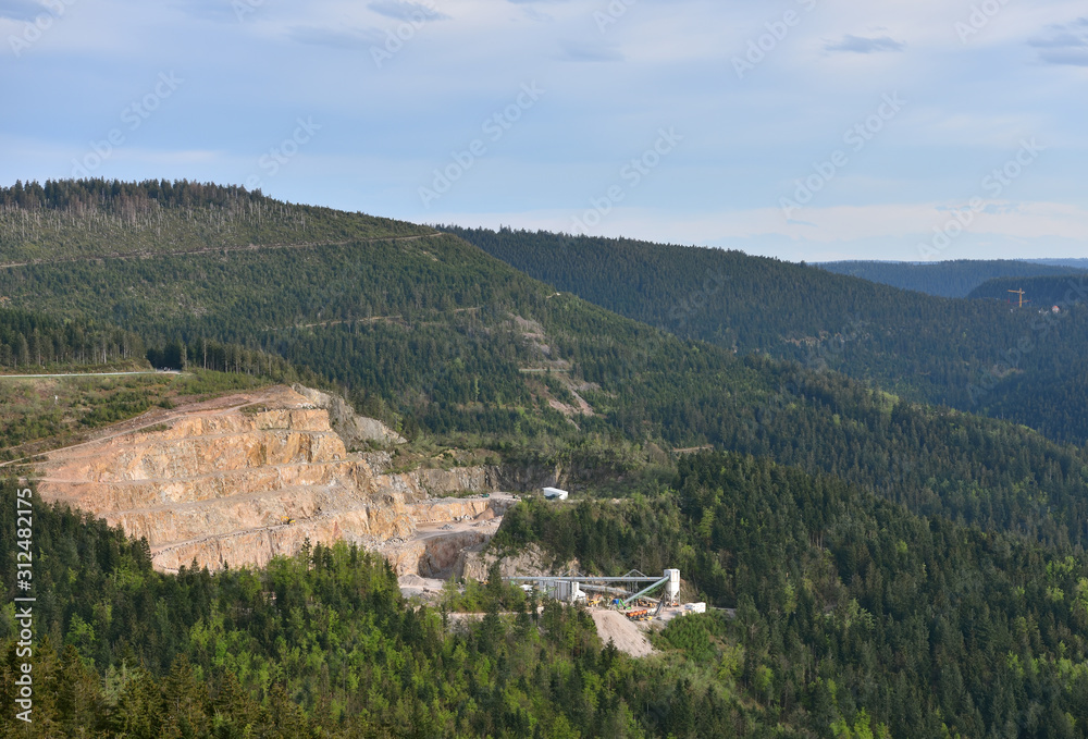 View of a quarry for stone mining in the European mountains. Industrial landscape mining