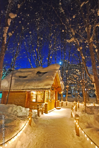 The light at night of Small house with snow covered at Ningle Terrace in Furano, Hokkaido, Japan