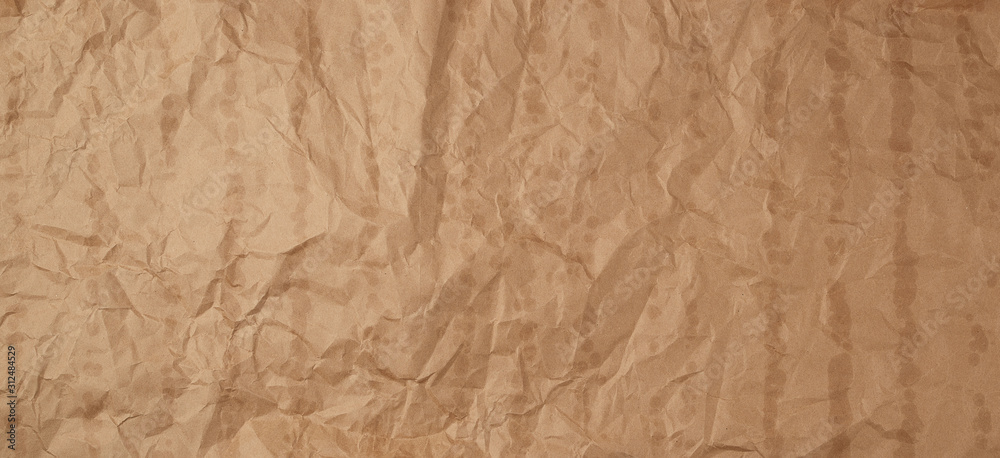 crumpled brown kraft paper texture with bold spots, full frame