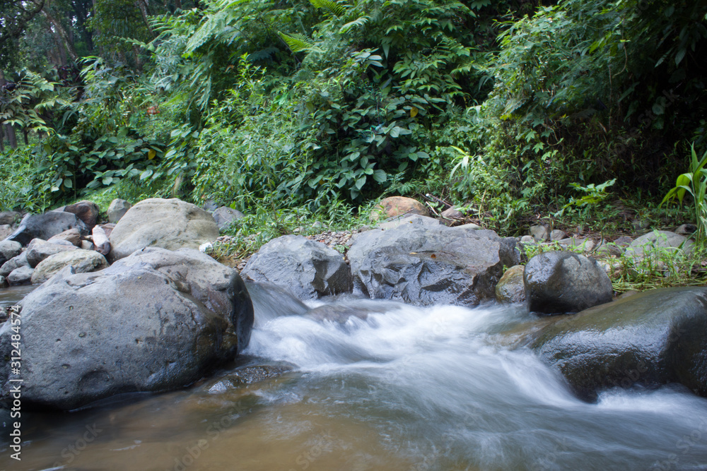 Naklejka premium spring water mountain river shot with long exposure, Beautiful flowing water
