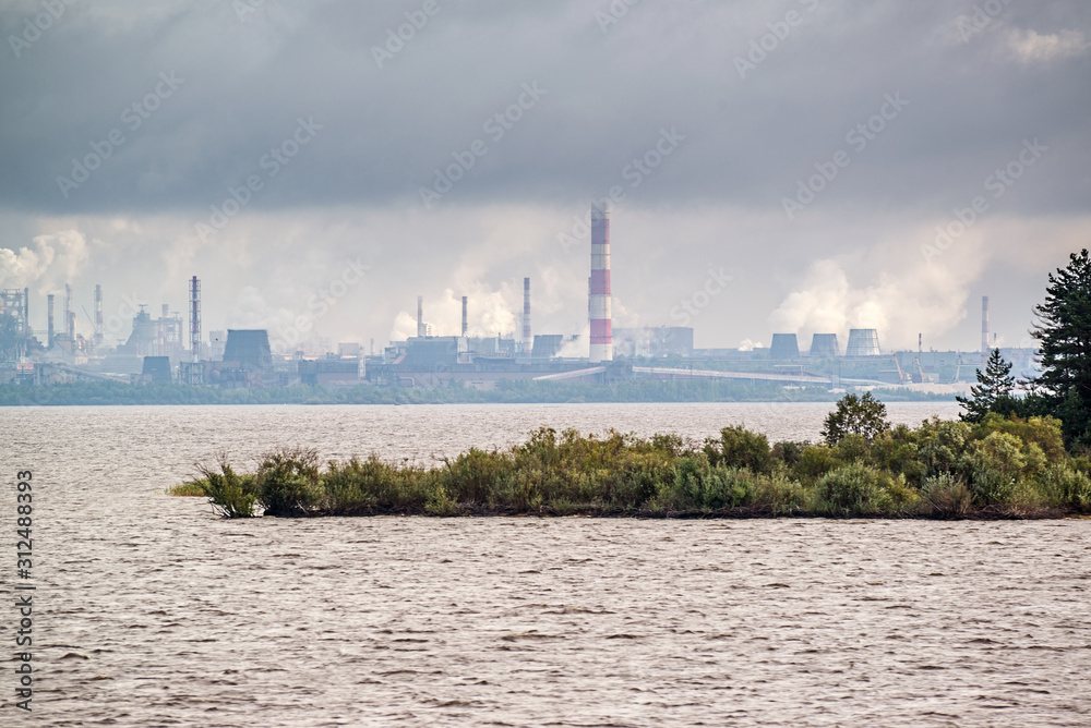 Sailing along the territory of metallurgical plant in smoke and mist Sailing along the territory of metallurgical plant in smoke and mist