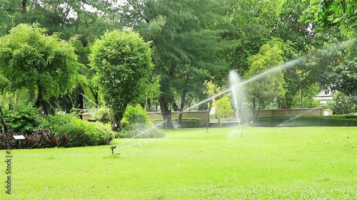 High power lawn sprinkler watering grass in garden
