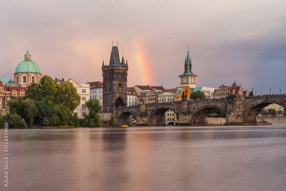 Old Town Bridge Tower and Charles Bridge with Rainbow in the sky.  Rainbow over the old town. Prague, Czech Republic.