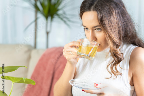 Woman drinking herb tea photo