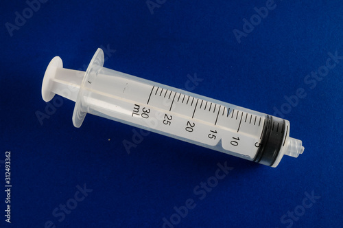 Syringe closeup isolated on colred background photo