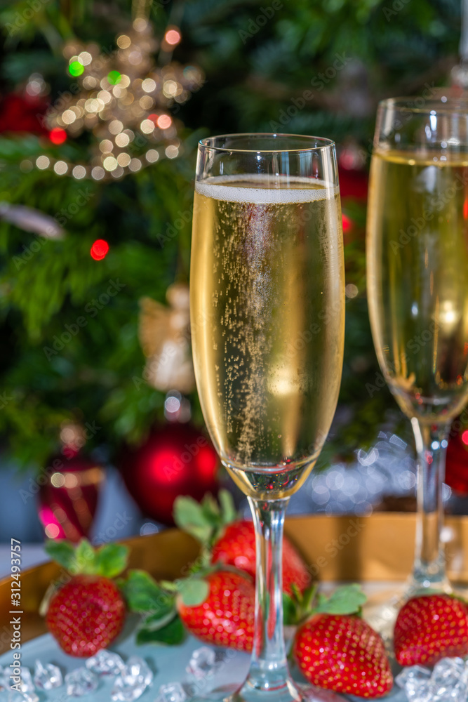 Champagne in glasses with strawberries on festive background Champagne in glasses with strawberries on festive background