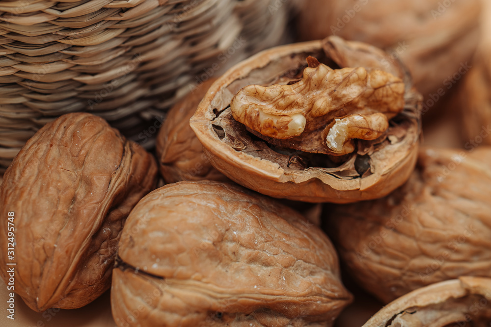 Healthy organic walnuts in a straw basket Healthy organic walnuts in a straw basket