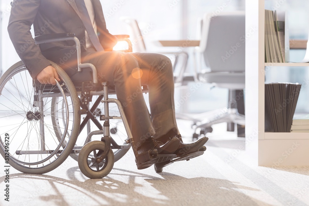 Low angle view of disabled businessman on wheelchair at modern office