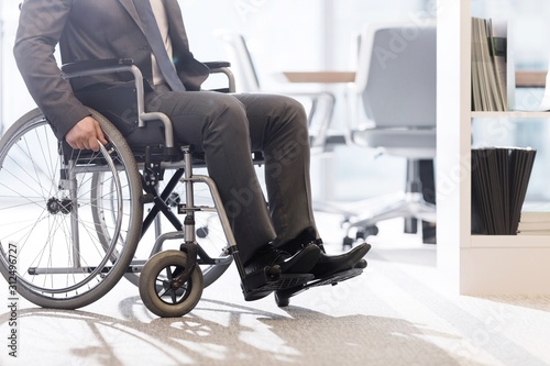Low angle view of disabled businessman on wheelchair at modern office