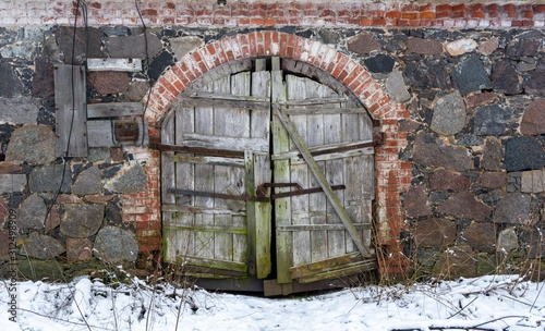 old wooden door in stone wall