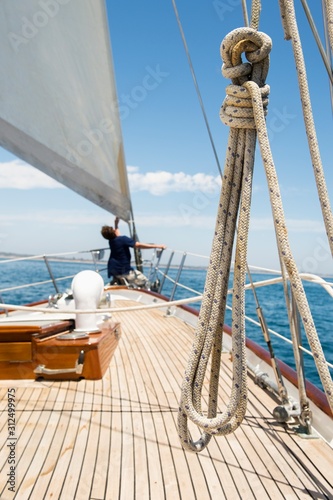 Valokuvatapetti Man working on prow of yacht
