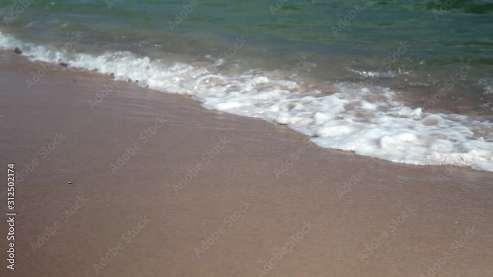 Closeup Of Sea Waves Washing Ashore A Sandy Beach. Slow motion. Closeup Of Sea Waves Washing Ashore A Sandy Beach. Slow motion.