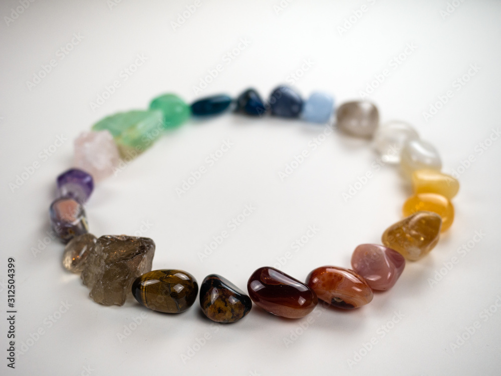 Crystals and gemstones - colorful spectrum arranged white background Crystals and gemstones - colorful spectrum arranged white background