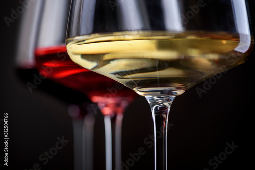 Bild auf Leinwand Three glass of red, rose and white wine over black background