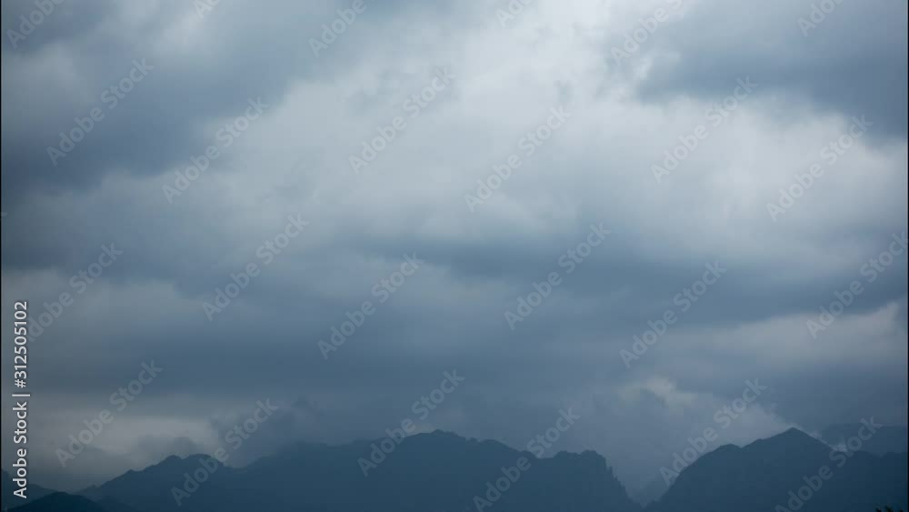 Timelapse of storm clouds rolling over Velebit Mountain Range in Paklenica National park, Croatia emerging from the clouds Timelapse of storm clouds rolling over Velebit Mountain Range in Paklenica National park, Croatia emerging from the clouds