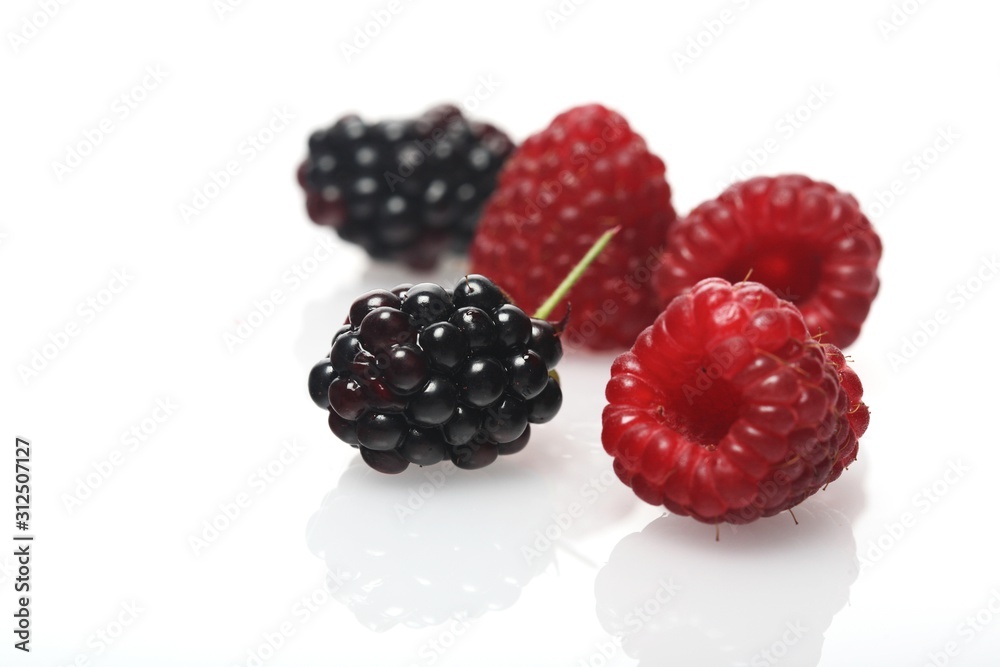 Raspberries and blackberries on white background - studio shot Raspberries and blackberries on white background - studio shot