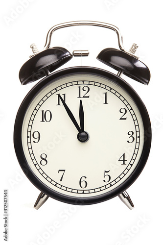 Black alarm clock isolated on white. Close up.