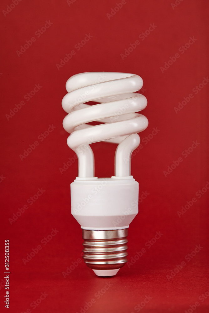 Energy saving lightbulb isolated on color background. Close up. Energy saving lightbulb isolated on color background. Close up.