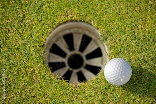 Close-up of golf ball near hole
