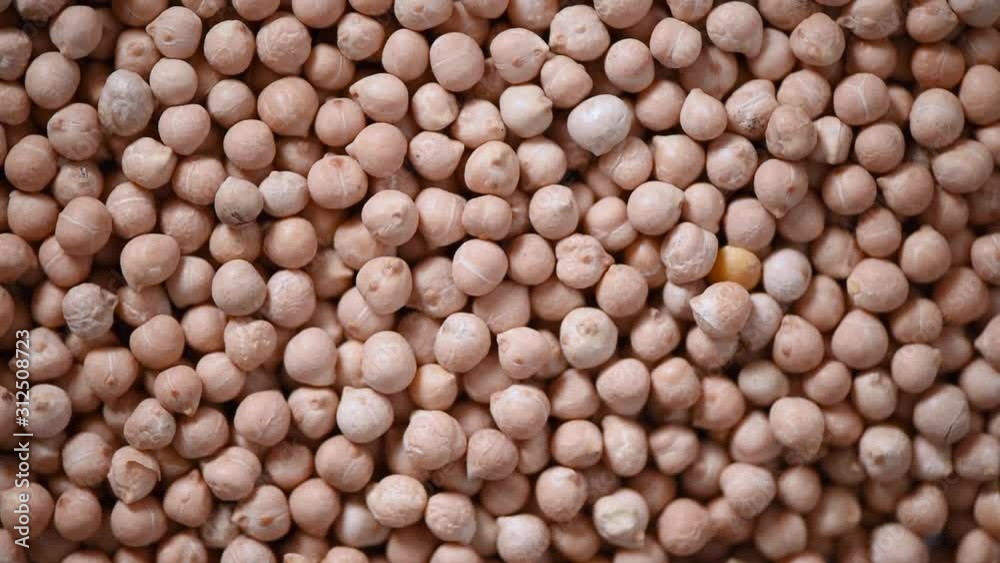 Raw organic dried chickpea texture on rotating background. Vegan healthy nutrition. Top view, copy space, healthy lifestyle concept. Raw organic dried chickpea texture on rotating background. Vegan healthy nutrition. Top view, copy space, healthy lifestyle concept.